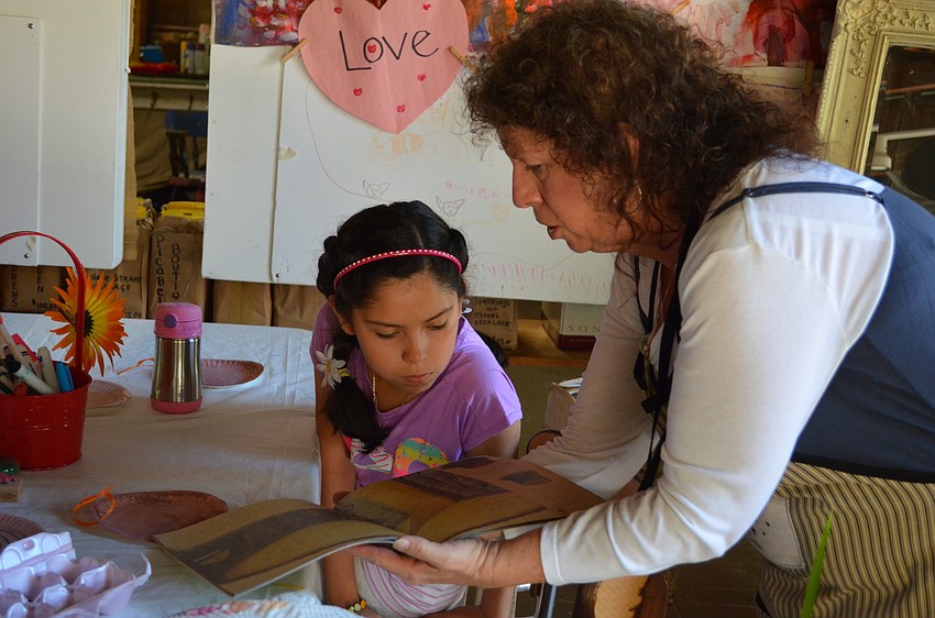 Robin Fulk explains to visitors how the rings of a tree reveal its age.