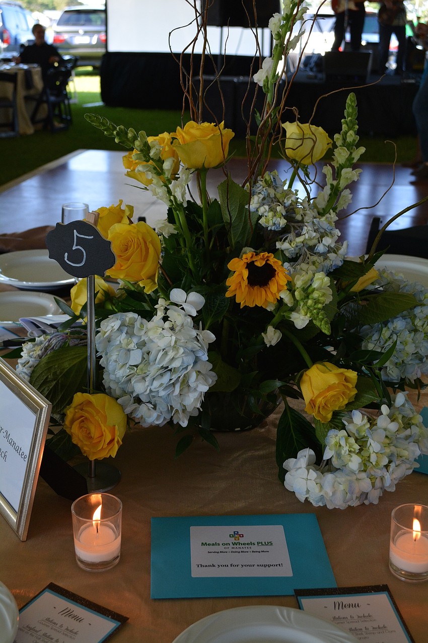 Each table was decorated with sunflowers and blue and yellow flowers.