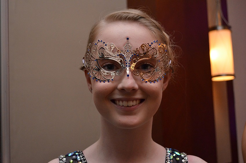 Laura Gwilliam shows off her intricate masquerade mask.