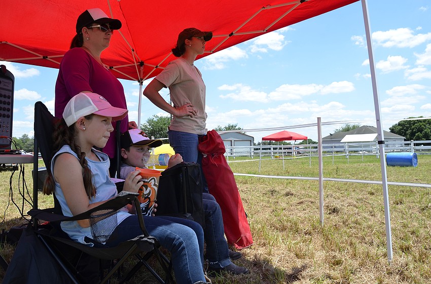 East County residents Carsyn, Trey and Shayne Kull watch the horsemanship demonstration with Amber Ozment, who is Carsyn's riding instructor.