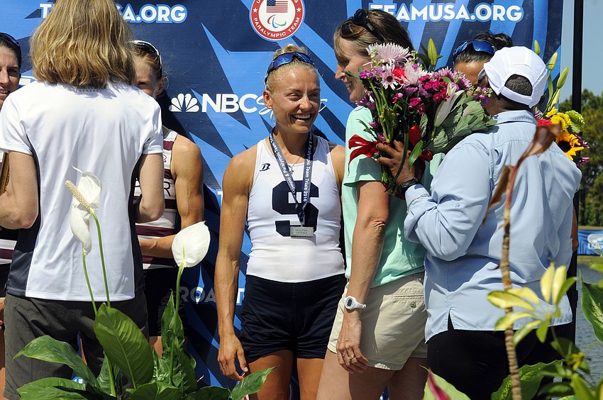 Sarasota Crew's Monica Whitehouse receives her bronze medal.
