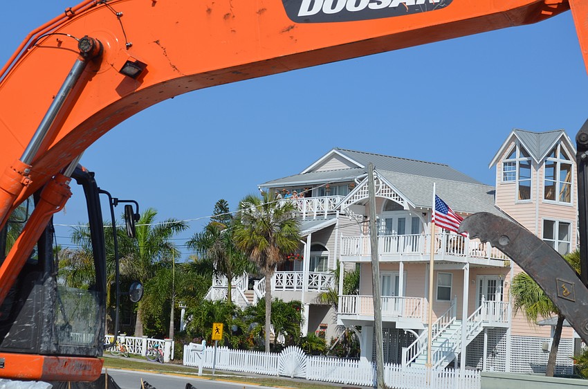 Longbeach Village residents watch the demolition from their balconies.