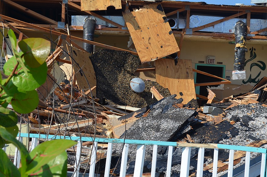 Contractors joked with a passing bicyclist that a car had crashed into the restaurant.