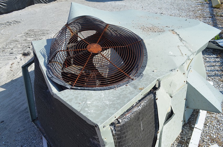 A mangled air conditioning unit was still buzzing and steaming this morning.