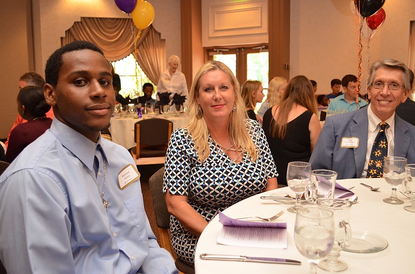 Booker High School senior Rosemon Alexis with Lori Lewis and Gary Leatherman