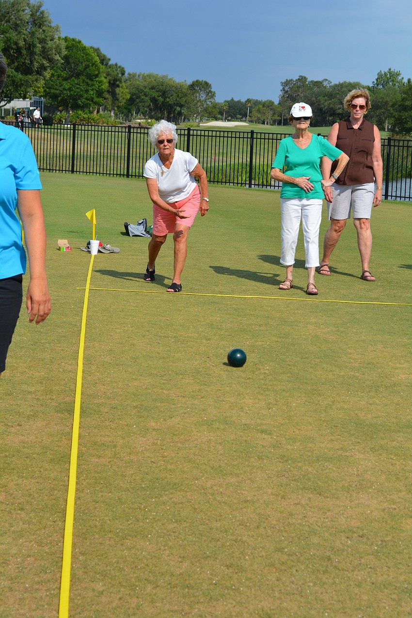 Lynn Dallesandro rolls her bocce ball.