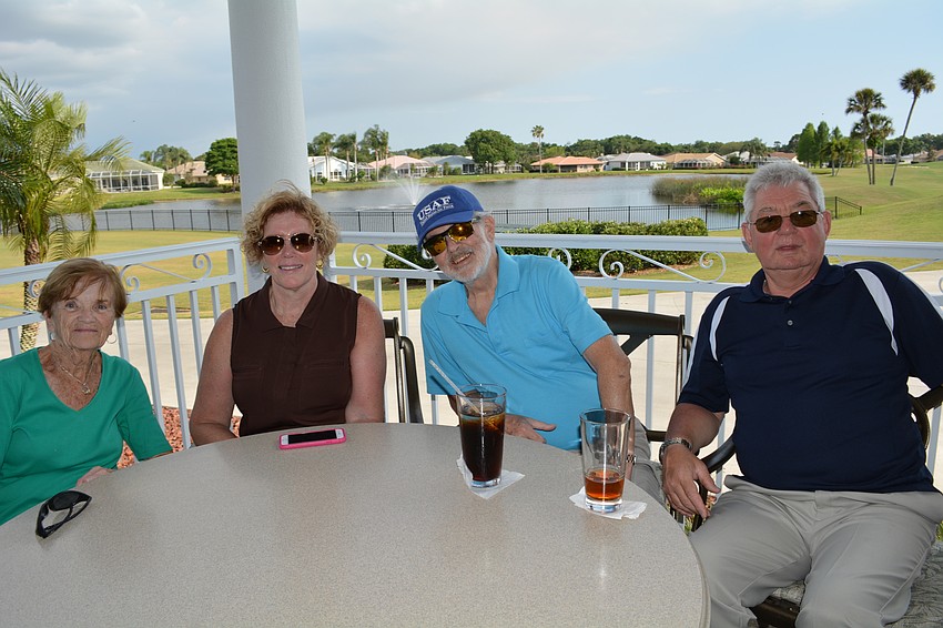 Mary McLaughlin, Mary and Dennis Crowley and Malcolm Laker find a corner patio table.
