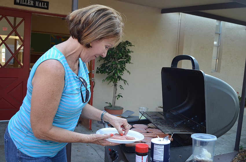 Cathy White adds to the grill.