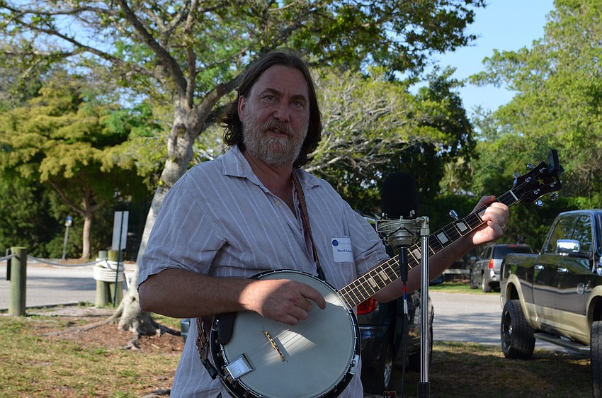 David Schmitz on the banjo performs for guests.