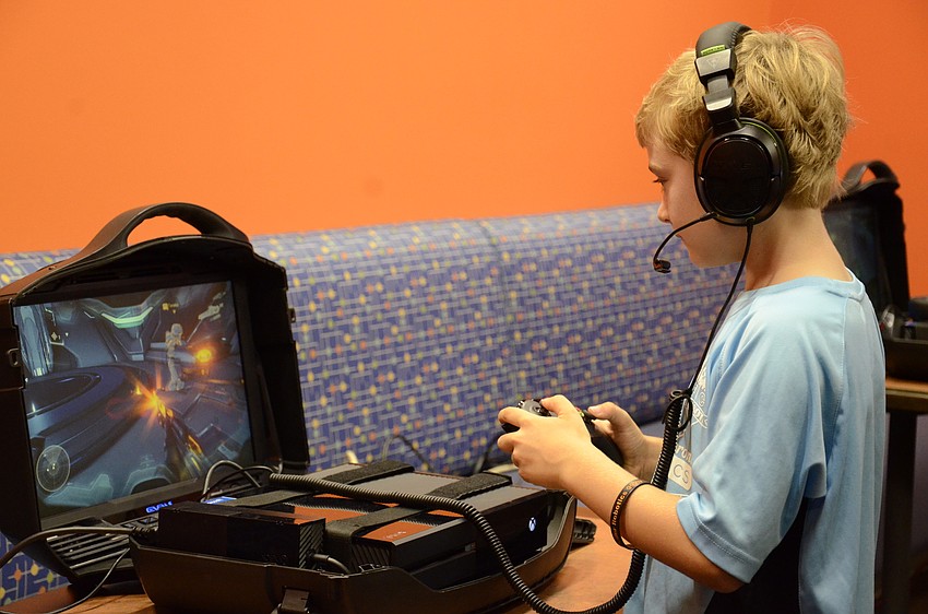 Mark Ruster of Sarasota tries out a game in the Microsoft room.
