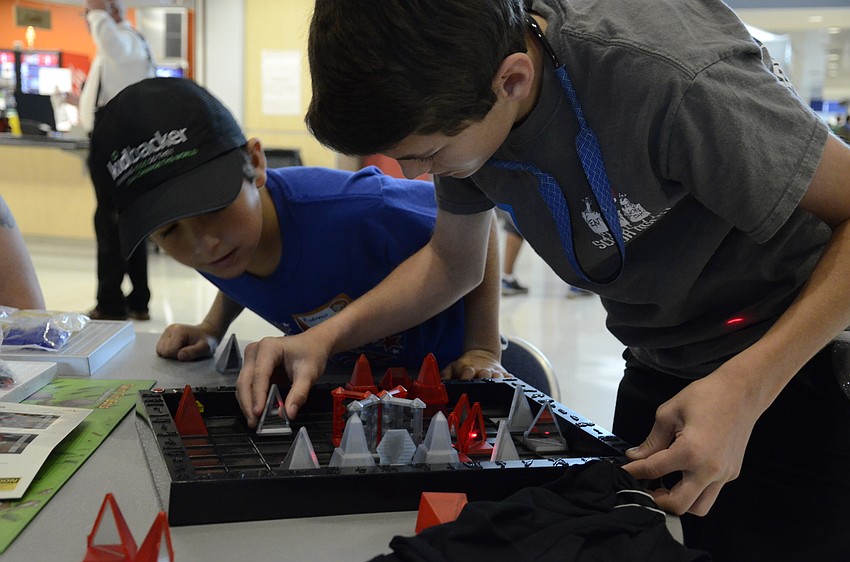 Andrew and Davis Graham of Bradenton play a game called Khet, which uses lasers to get pieces removed from the board.