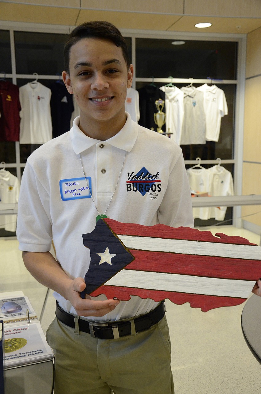 Yaddiel Burgos of Bradenton shows off his favorite piece he's made. He designs the project on Adobe Illustrator and cuts it out with a laser cutter.