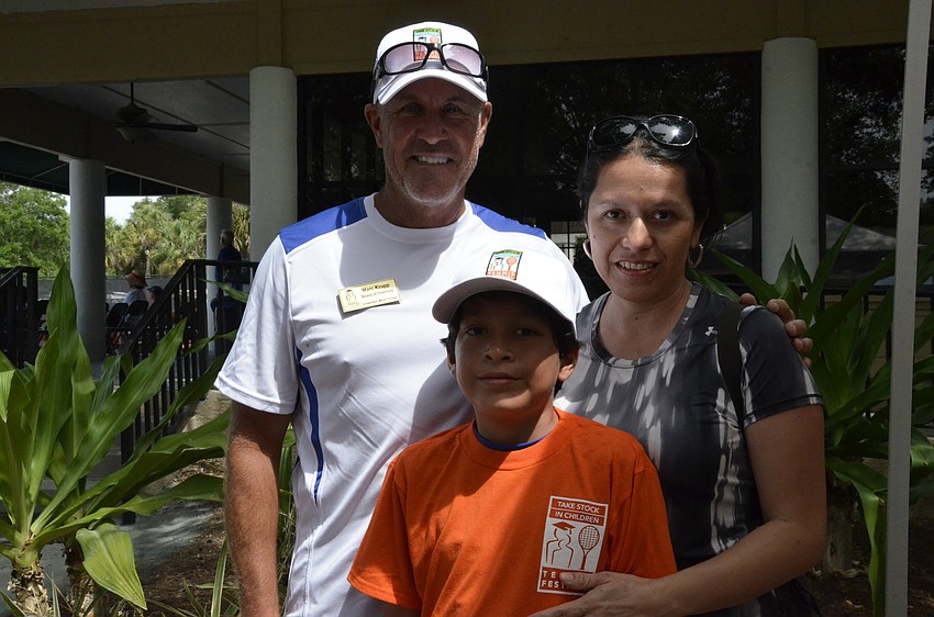 Tennis instructor Marc Krupp with Nydia Chavez of Bradenton and her son, Alessandro Caballero