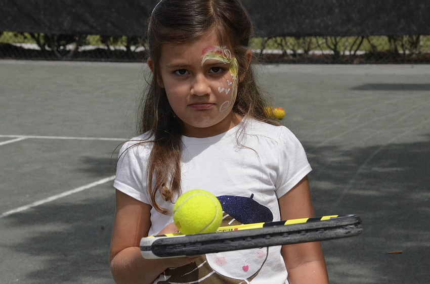 Stella Averill of Bradenton carefully balances her tennis ball.
