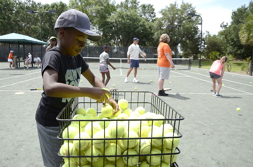 Nicholas Bertram of Palmetto grabs more balls to practice his toss.