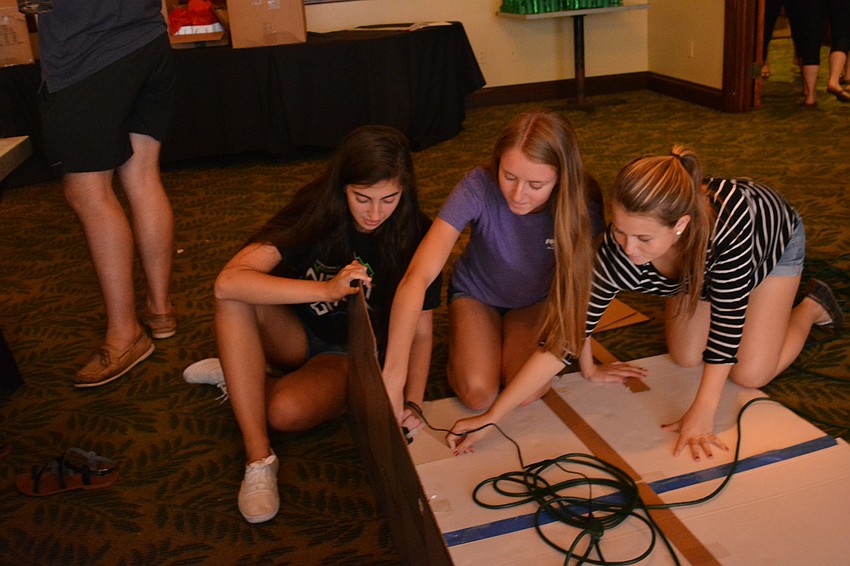 Braden River juniors Sarah Shumway, Emily Margolis and Shelby Egan work on decorations before the big night.