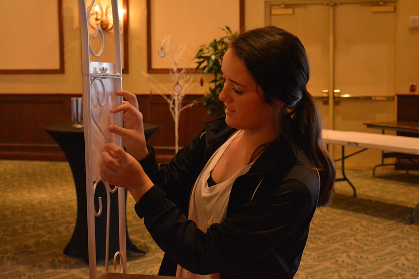 Braden River junior Raeann Folds gets a decoration just right  in preparation for the prom.
