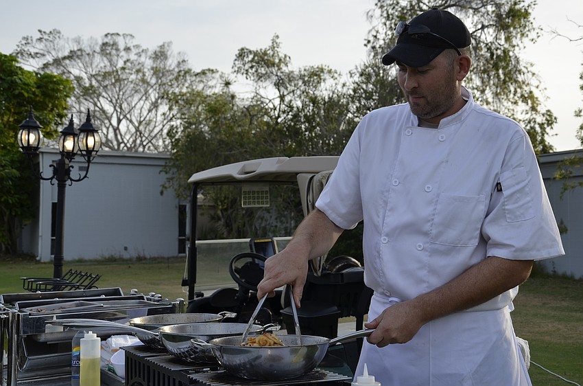 Brian Chrisman, a Longboat Key Club banquet chef, stirs up shrimp fajitas.