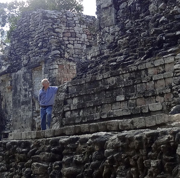 Carl Abbott poses with ancient Maya ruins. Maya architecture has inspired and informed some of Abbott's recent work.