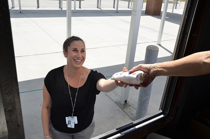 Natasha Lambertson gets an ice cream bar from the White Pony Ice Cream Truck.