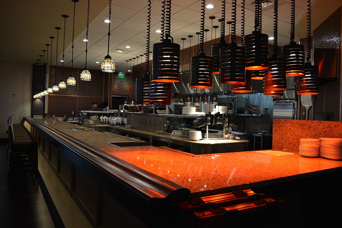 An open kitchen allows patrons to watch chefs in action and also creates an opportunity for interaction between the kitchen and guests. The kitchen features a pizza oven.