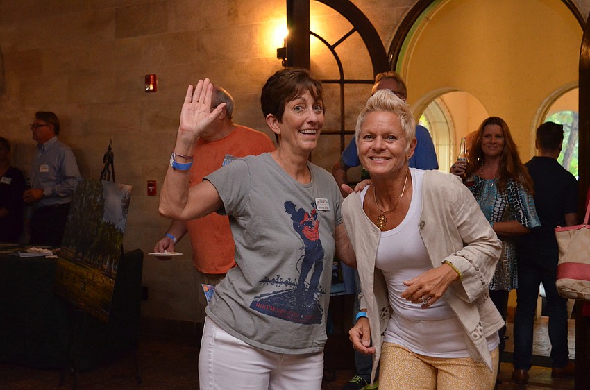 Johnette Isham and Claudia Deming make a dance floor in the foyer of the Powel Crosley Estate & Museum.