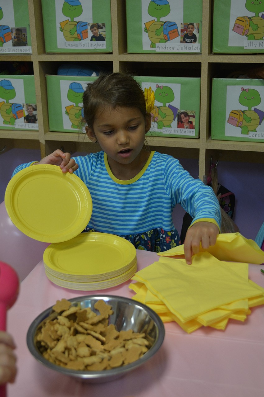 Haylie Thompson grabs a plate for her mother, Nayla.