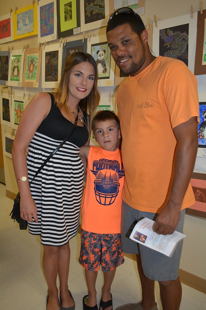 Amber Kelley and Dustin Johnson, right, bring their son Ayden Demoran, center.