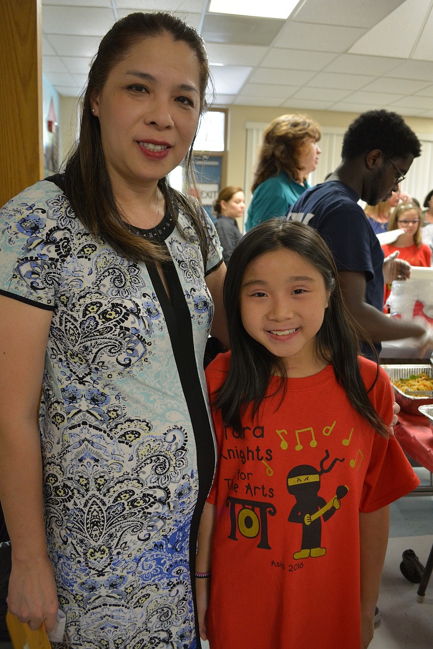 Theresa and Haylen Hang oversee the buffet provided by Theresa's brother-in-law, Hoa Hang, owner of Nam Fong Restaurant.