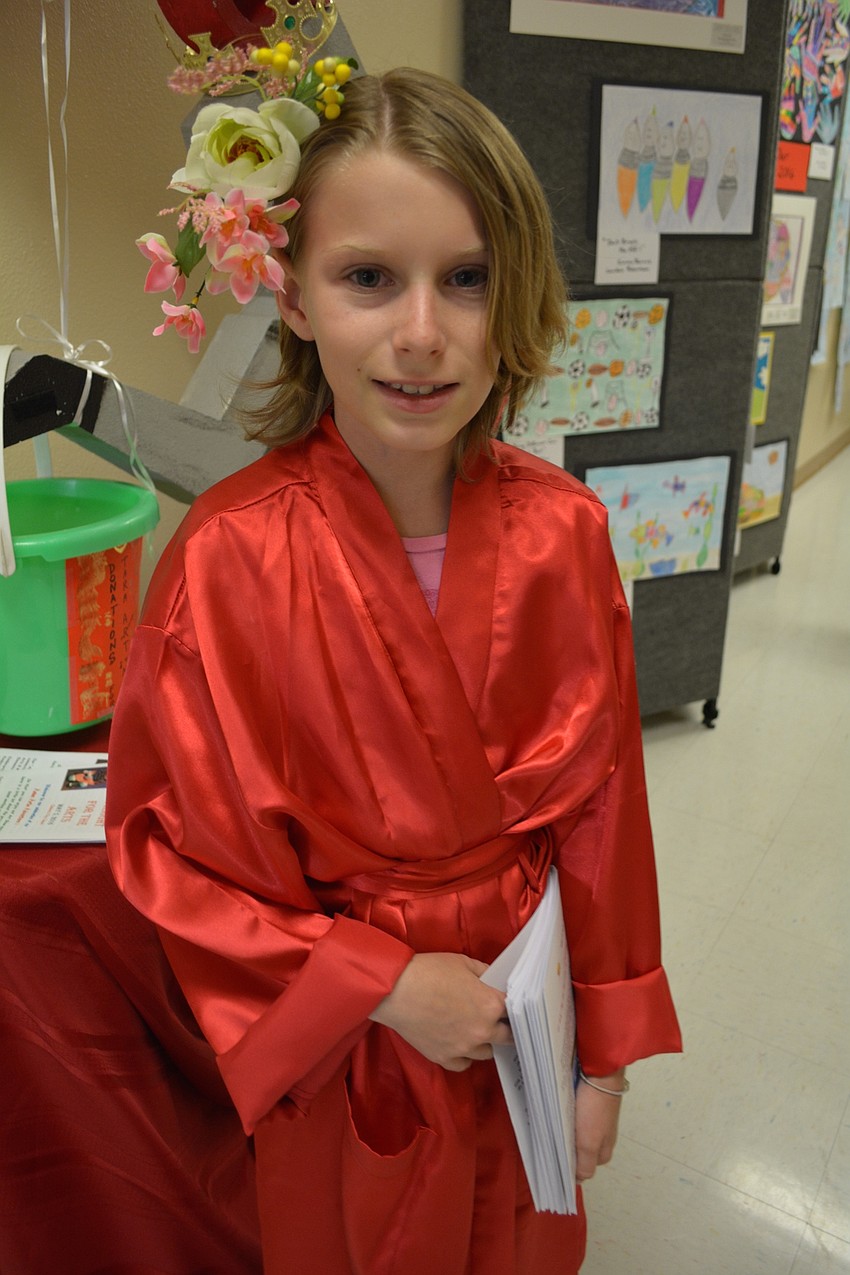 Beatrix Turner, a fifth-grader, passes out programs.