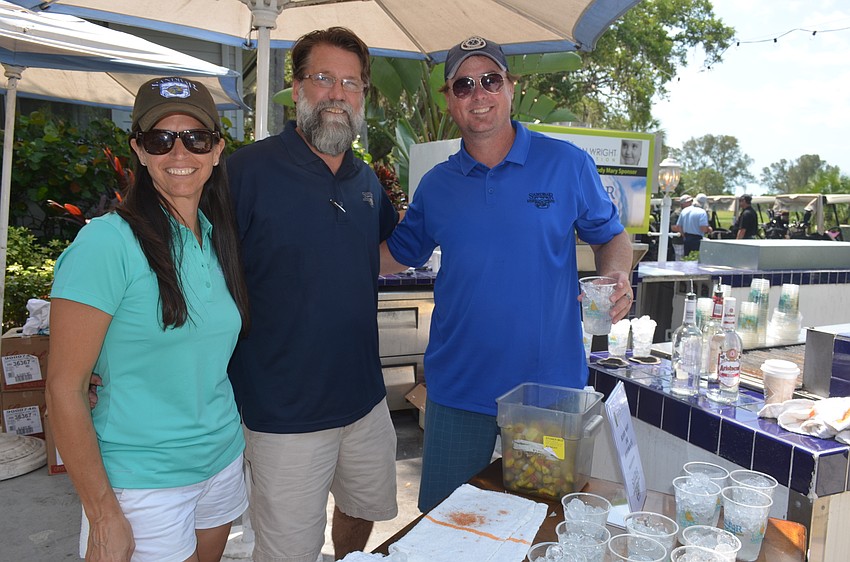 Johanna and Robert Baugh and Sean McCarthy, of the Sandbar Restaurant, serve Bloody Marys and Moscow mules.