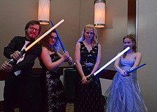 Caleb Pryor, Cyanne Doyle, Gabrielle Nutter and Olivia Neal duel with lightsabers during the "A Galaxy Far Far Away" prom.