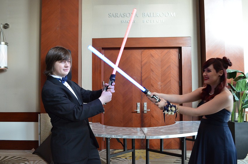 Students Chase Causey and Michaela Fox incorporated the theme by bringing lightsabers.