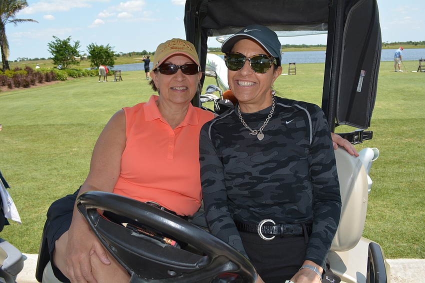 Anne Ryan, of Decision Associates, and Lisa Krouse, of FCCI, ready to play.