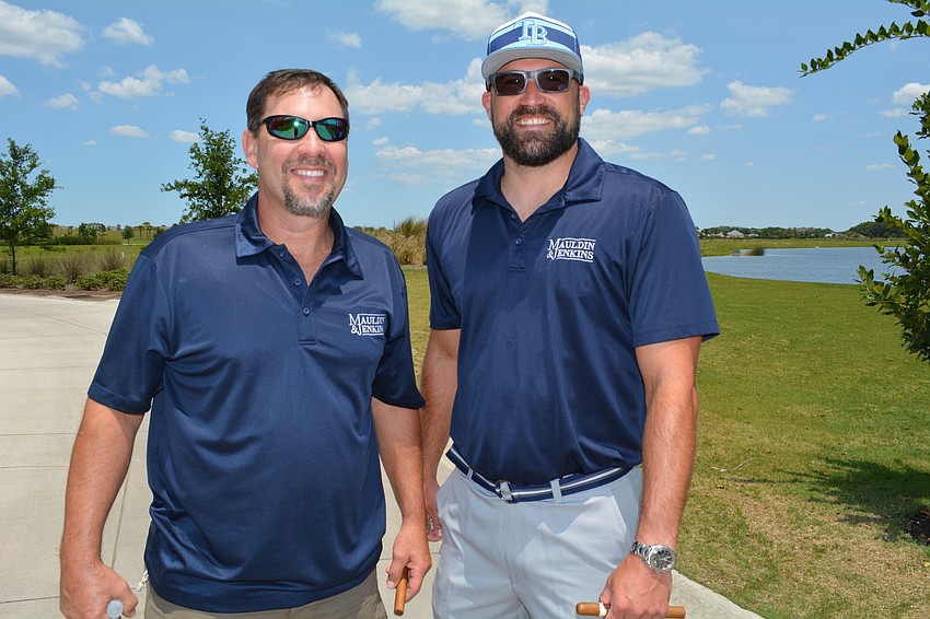 Steve Parent and Ron Marshall, of Mauldin and Jenkins, enjoy cigars on the course.
