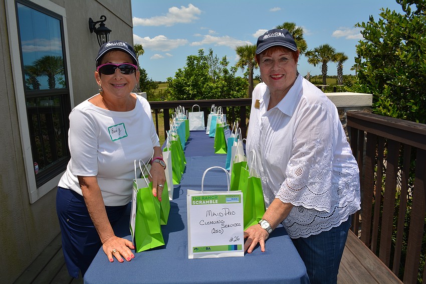 Esplanade resident and retired Business Alliance employee Barb Zdziarski helps Janet Arena, of the Van Wezel, with the raffle.