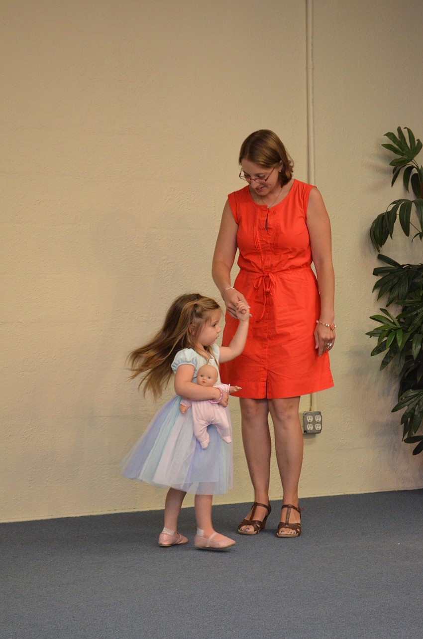 Mother and daughter Michelle and Madeleine Gneiady dance on stage.