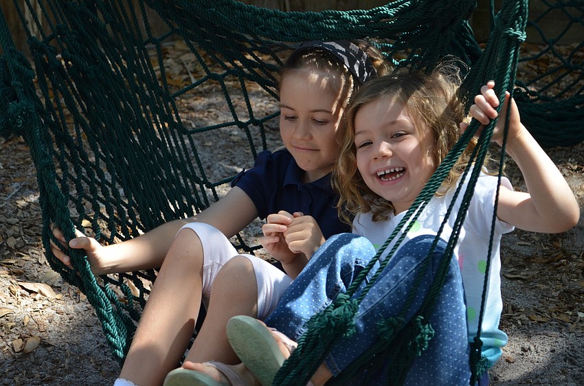 Ella Cardell and Fiona Quinto spin on the hammock swing.
