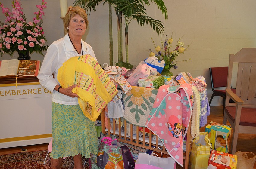 Judy Achre with the church’s donations to Cyesis