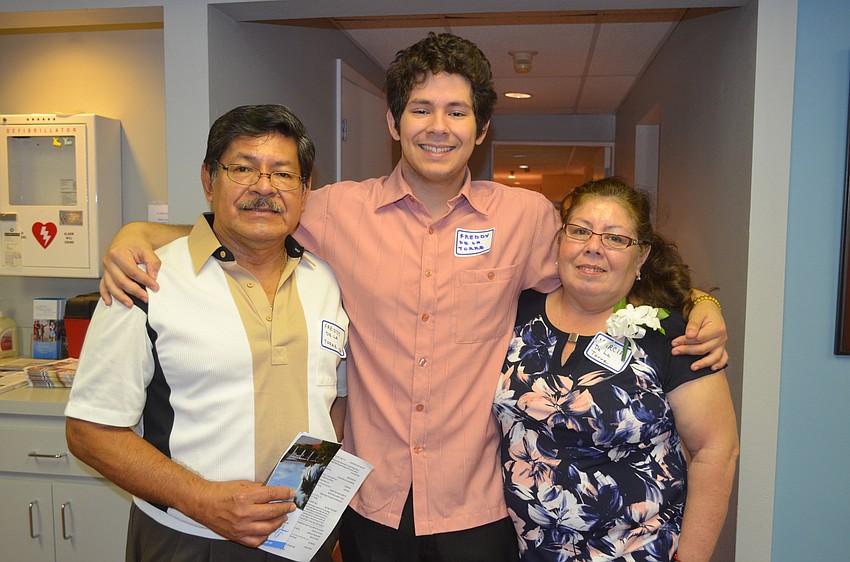 Scholarship recipient Freddy De La Torre, center, with parents, Freddy and Marcia