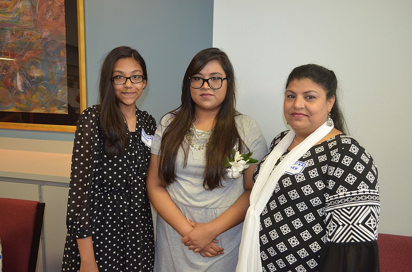 Scholarship recipient Ayshah Zaman, center, with sister, Subrina, and mother, Morjina