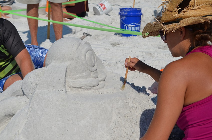 Angela Albertson works on the face for 