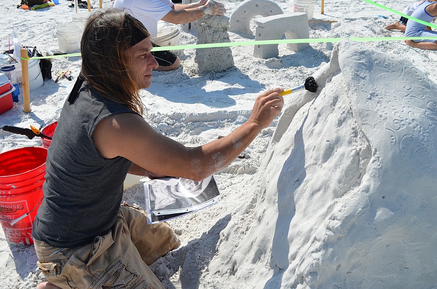 Long-time competitor Damon Meri brushes sand from 