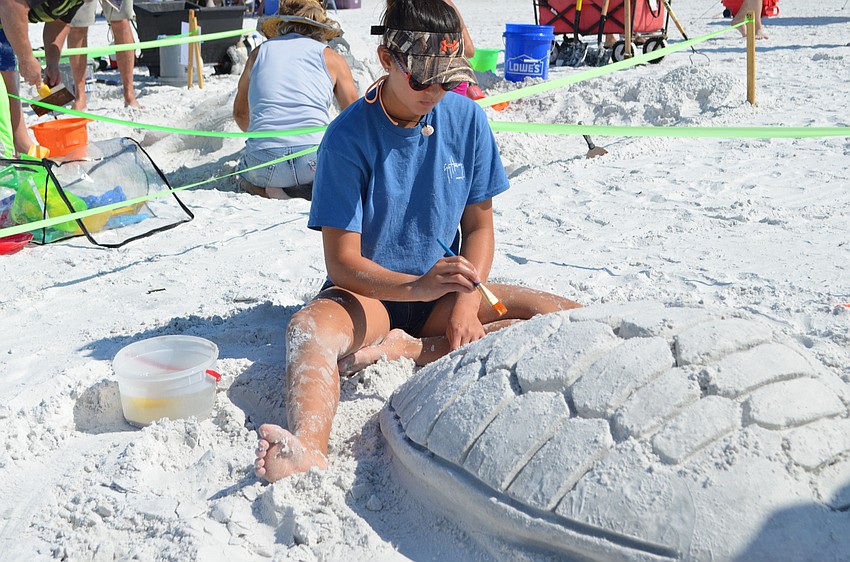 Lilly Loo carves the shell of her sculpture 