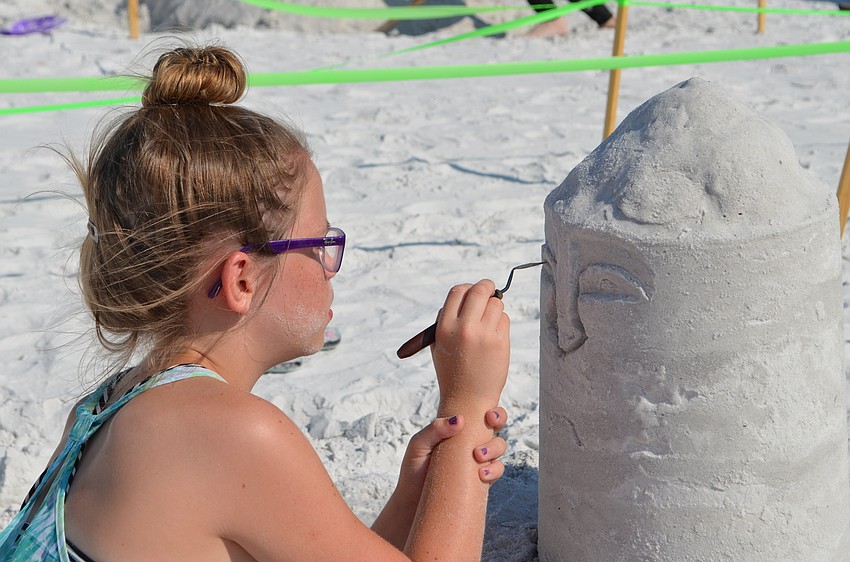 Olivia Peck concentrates on the face for her sculpture 