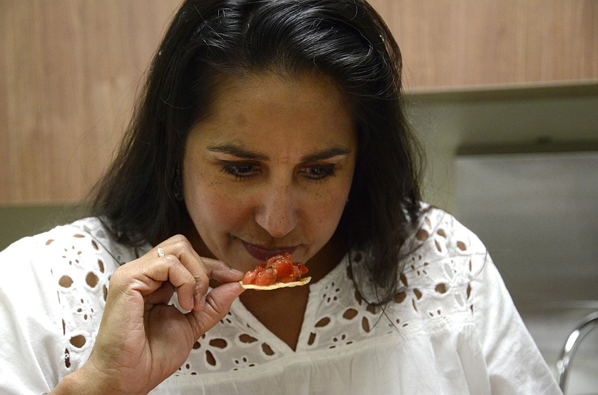 Myrna Flores sniffed each entry before trying it to get an idea of the ingredients within the dip.
