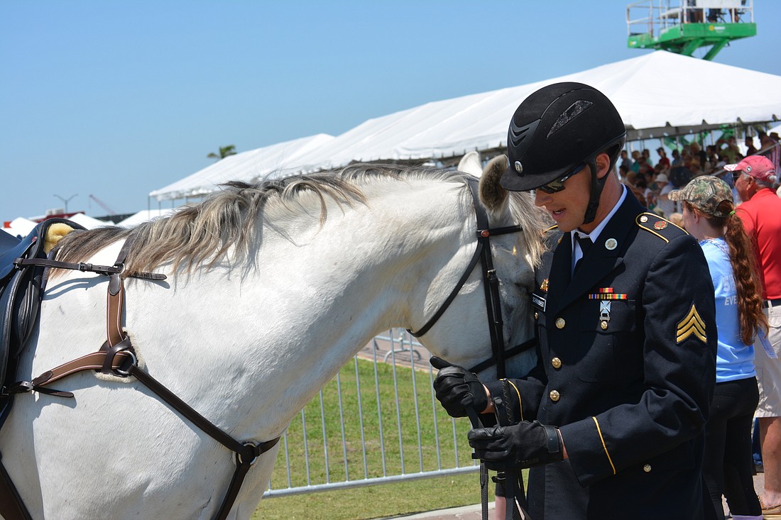 Nathan Schrimsher gives some love to his horse, Hanover, after his win in the riding portion of the modern pentathlon.