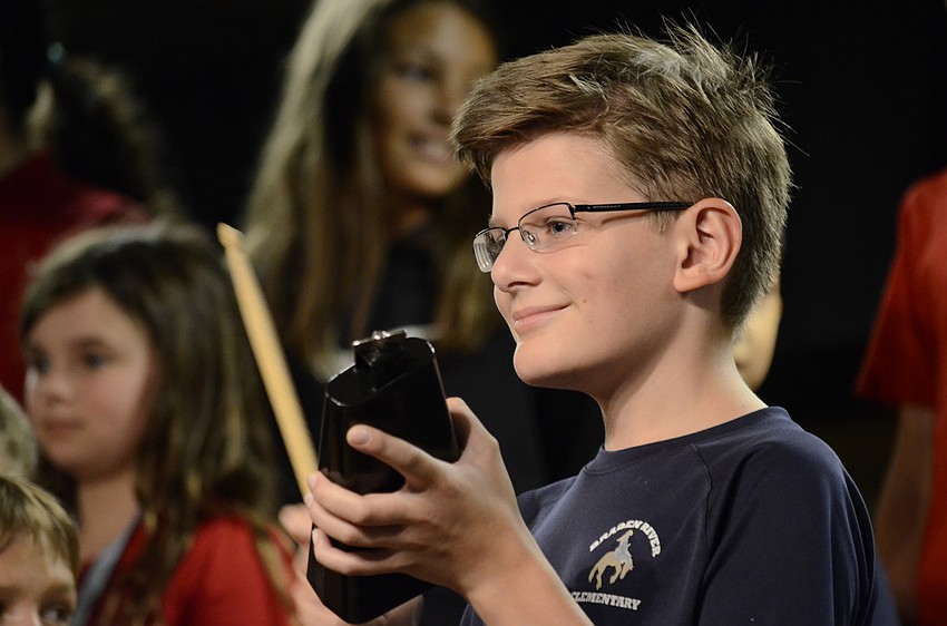 Alex de Boggende taps the cowbell to start off a Yoruban welcome song.