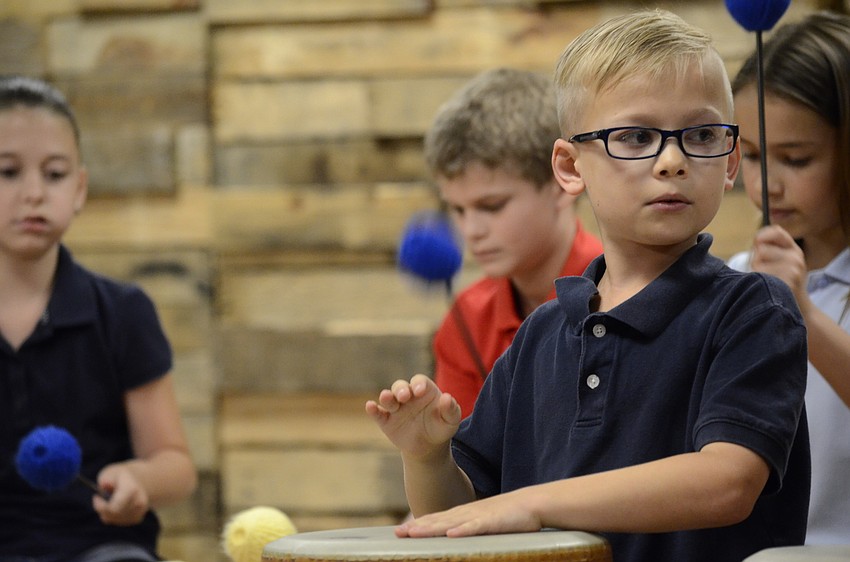 Ben Hanson plays the tubano drum during the Zimbabwean song.