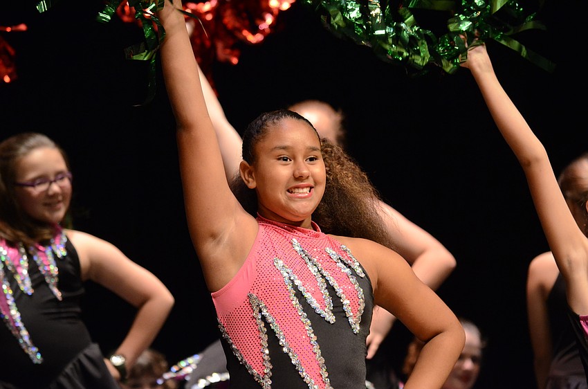 Tara student Amaya Dunbar shakes her hoop during a Christmas routine to Trans-Siberian Orchestra.